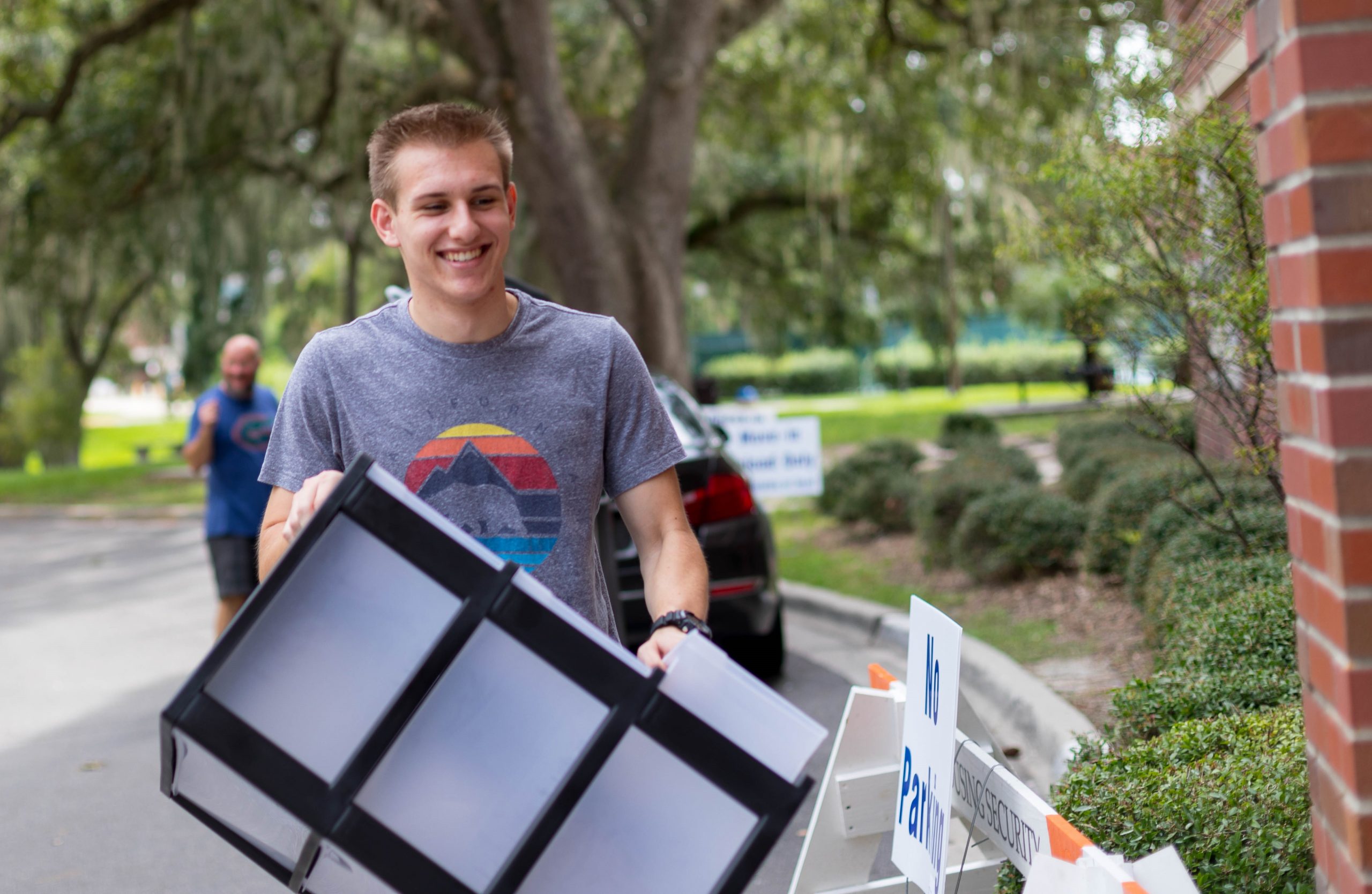 A student carries a small container into Yulee hall.