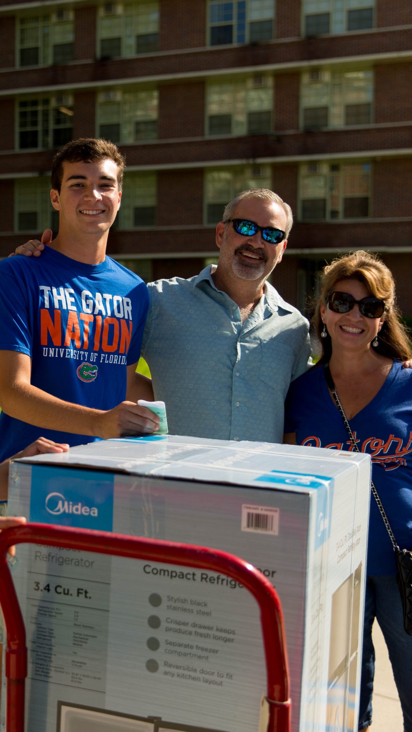 a family stands together and poses for a picture.