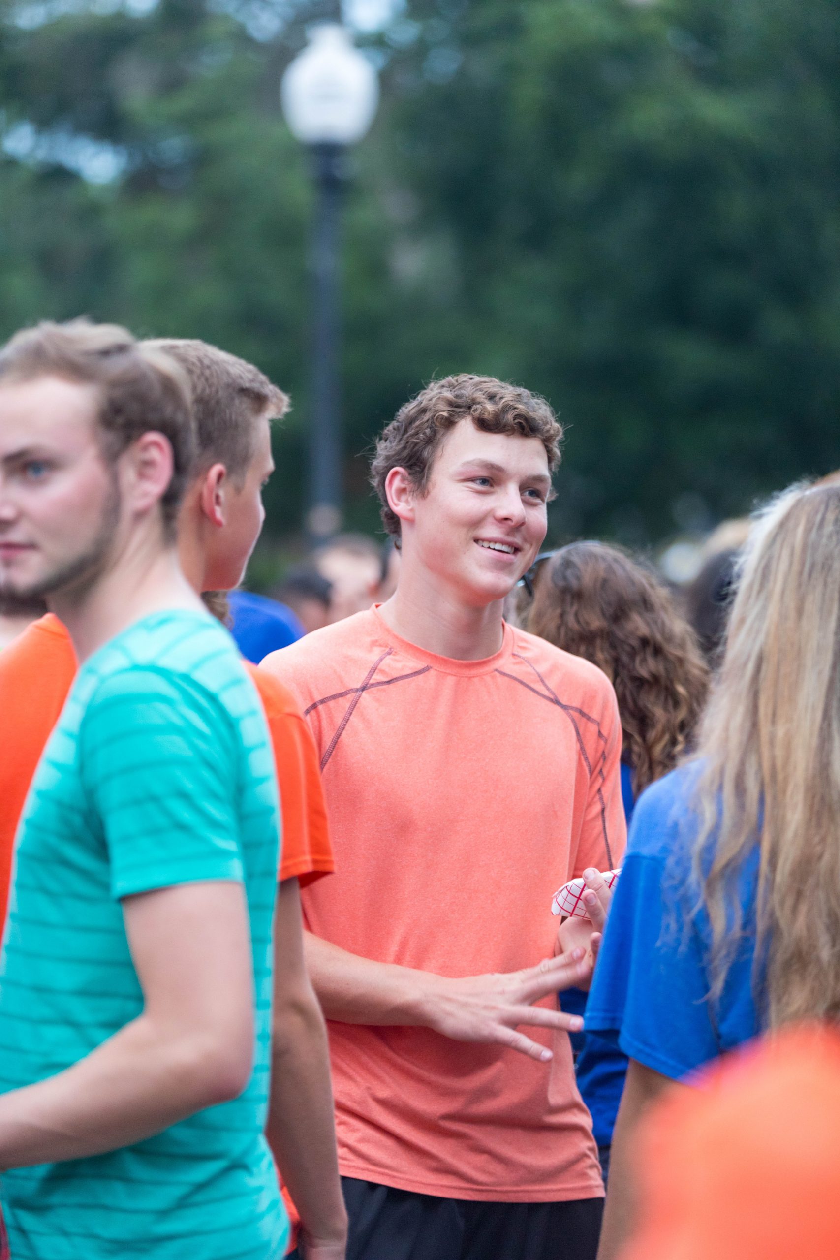 A male student chats with a new friend during a housing event.