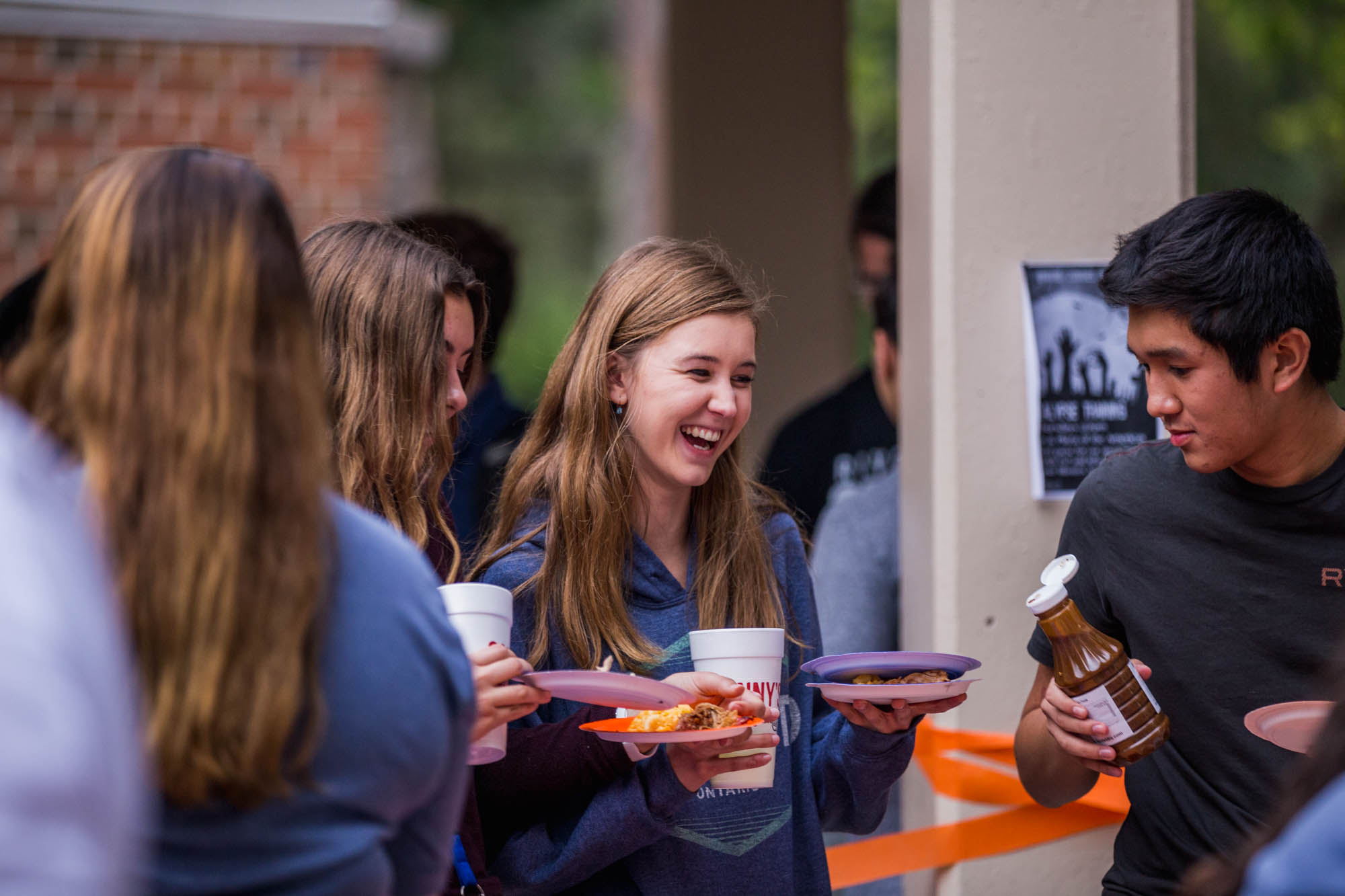 A student collects a plate of food at an event.