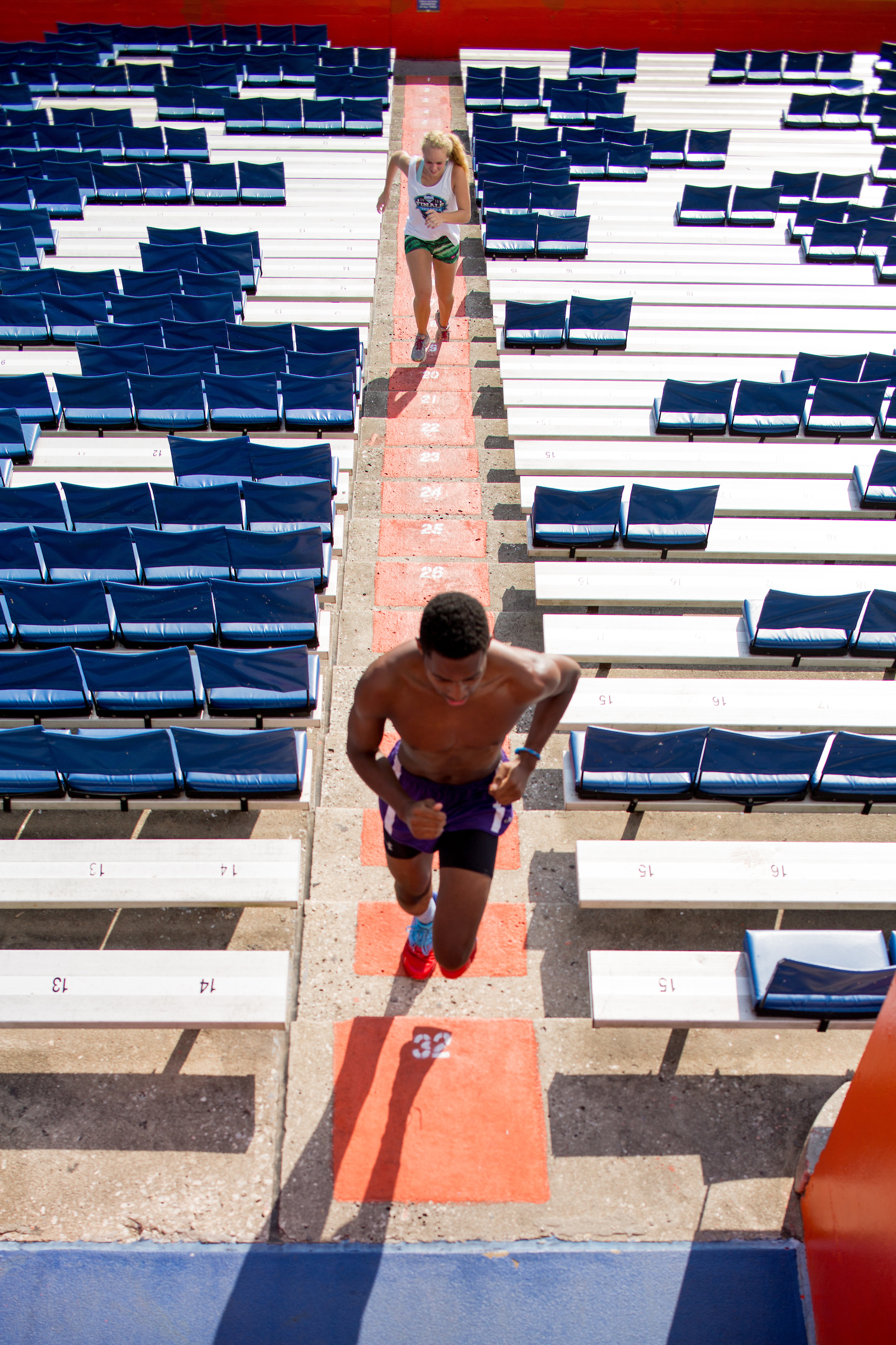 a male students runs stadiums inside ben hill griffin stadium.