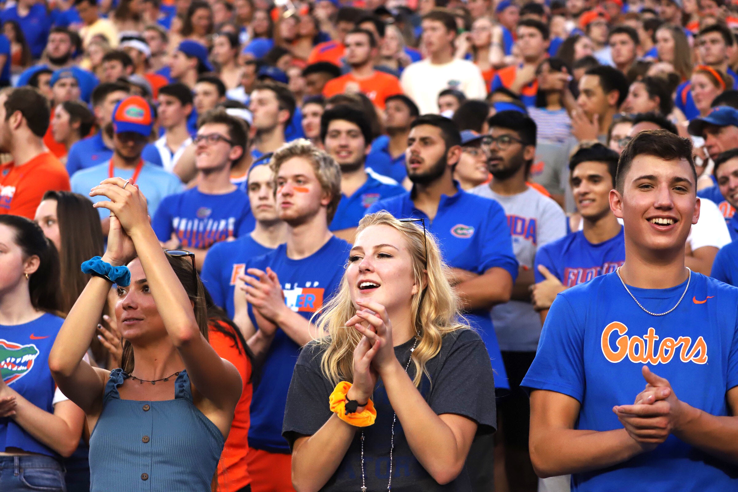 Student attend a football game in the swamp