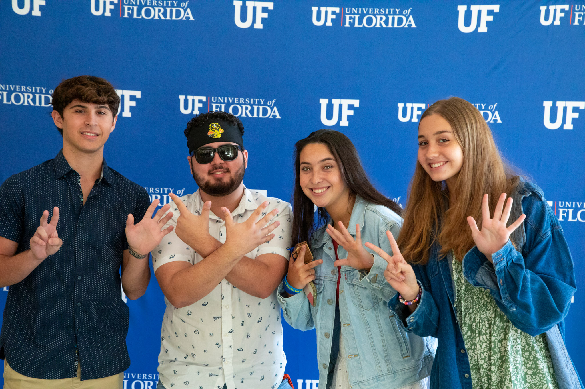 Four students hold up "25" at the Ignite Graduation Ceremony.