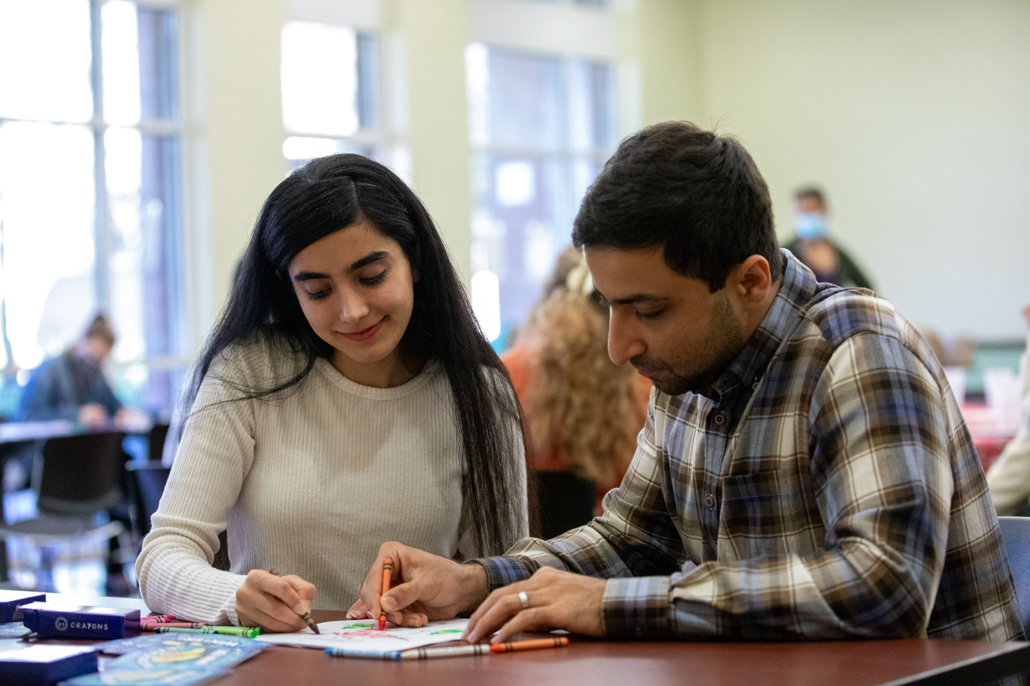 a couple talks together and looks at a paper.