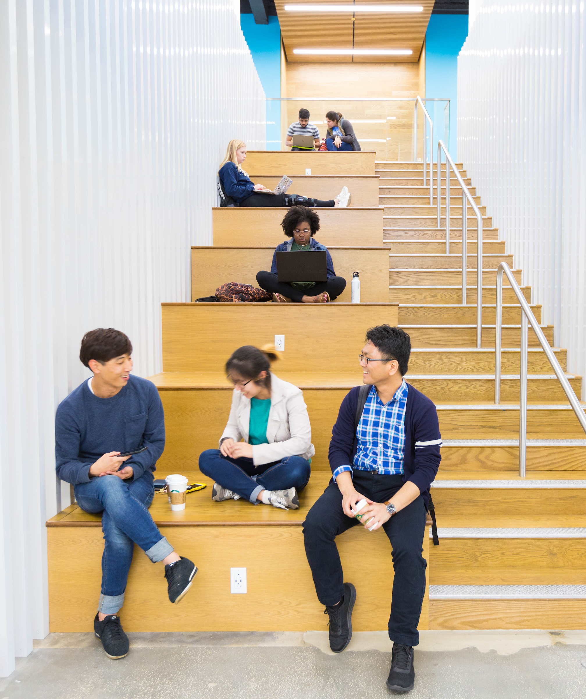 Three students talk together in Newell Hall.