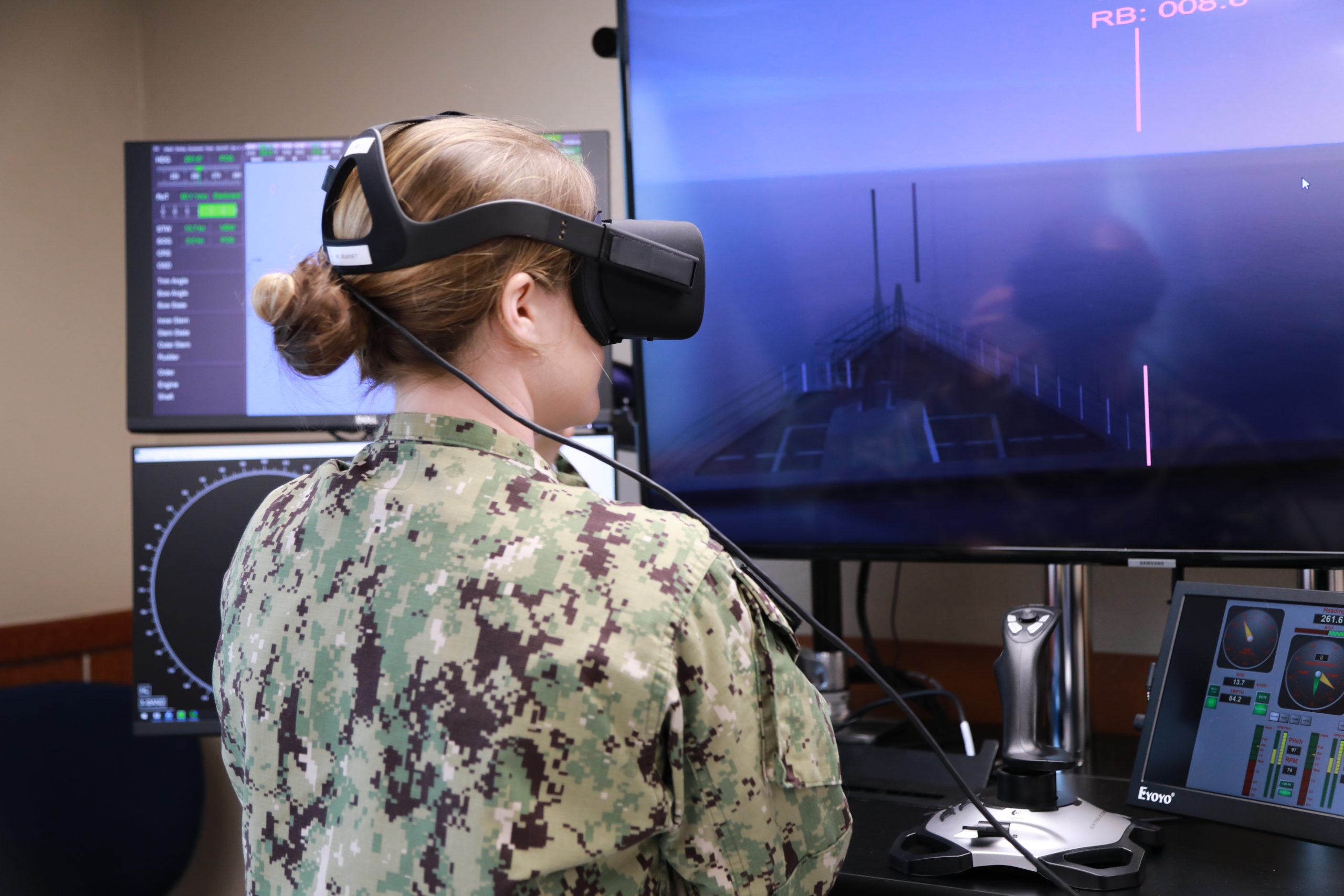 An ROTC student virtually drives a navy ship during a simulation exercise..