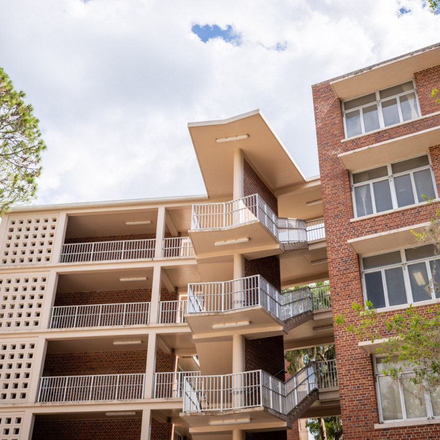 the brick exterior of Simpson hall during a sunny day in Florida.